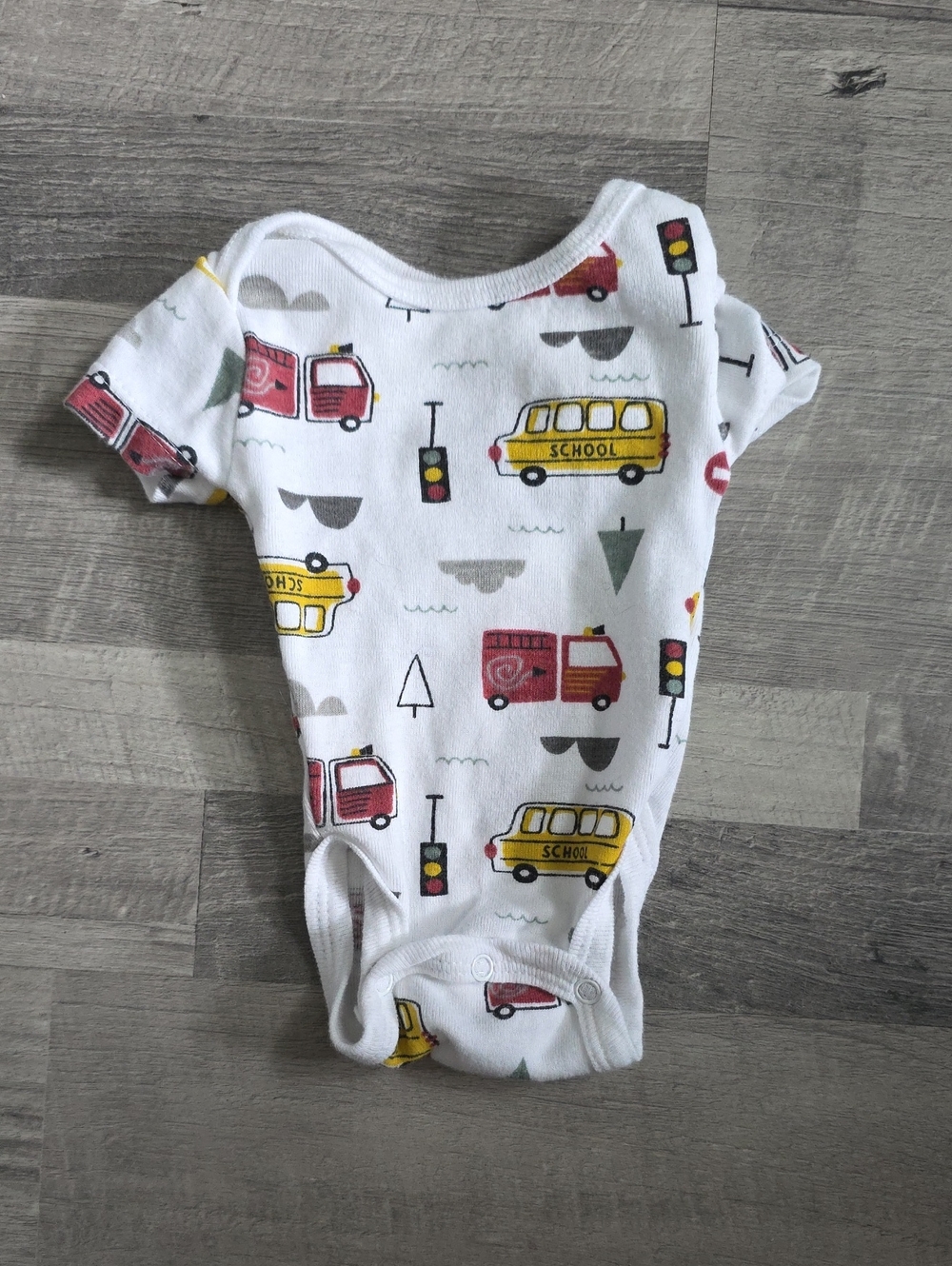 Koala Kids • White Onesie with Yellow School Bus & Red Truck Print
